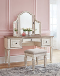 Realyn Queen Upholstery Panel Bed, Dresser, Chest, Nightstand, and Vanity Set
