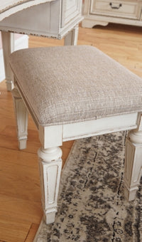 Realyn Queen Upholstery Panel Bed, Dresser, Chest, Nightstand, and Vanity Set